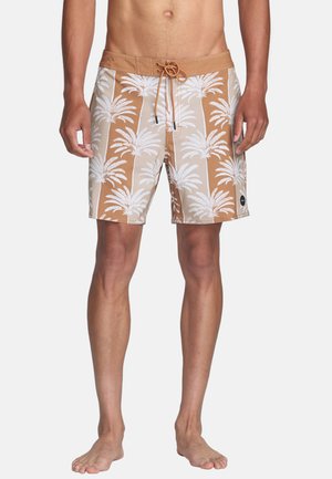 Brown swim shorts with white palm tree pattern, drawstring waist, and a black logo patch on the side. Made from lightweight fabric.