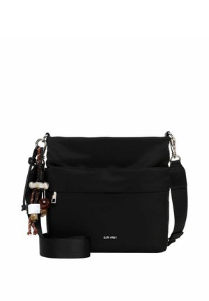 Sac bandoulière noir avec sangle réglable et pompons décoratifs perlés, avec une poche zippée à l'avant et le nom de la marque Suri Frey.