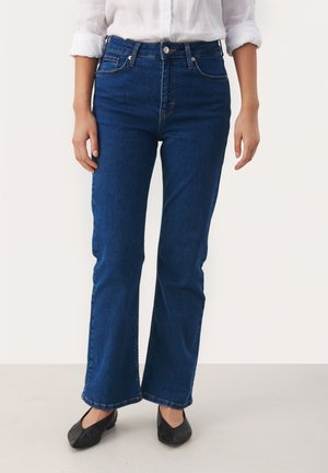 Blue denim flared jeans with a high waist, front pockets, and belt loops. The fabric features a smooth texture and minimal stitching details.