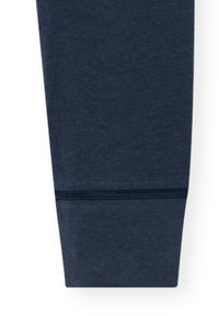 Navy cotton jogger cuff with a textured finish, featuring a smooth hem and subtle stitching detail near the bottom.