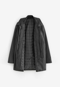Schwarze Outdoor-Jacke mit einem softshellartigen Außenmaterial, Reißverschluss und Druckknopfverschluss, gestepptem Innenfutter und Kapuze. Verfügt über minimale Akzente und ein elegantes Design.