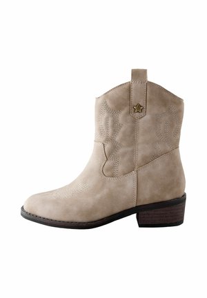 Beige suede ankle cowboy boot with stitched decorative patterns and a small star-shaped metal accent on the pull strap.