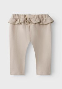 Leggings de algodón beige con una cinturilla con volantes, que presentan un acabado texturizado y un sutil ribete a lo largo de los volantes. Diseño de pierna ajustada.