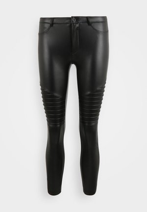 Leggings en simili cuir noir avec une finition lisse, dotées de détails en panneaux et d'accents côtelés sur les jambes inférieures. Design slim fit.
