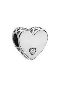Silver heart-shaped charm with a small heart-cut crystal detail at the center and decorative cutouts along the edges. Smooth surface.