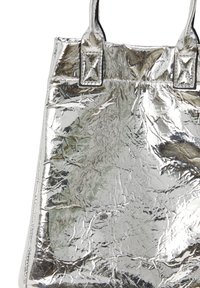 Ezüst fémes válltáska gyűrött textúrával, két erős pánttal és szögletes díszítésekkel a rögzítési pontoknál.