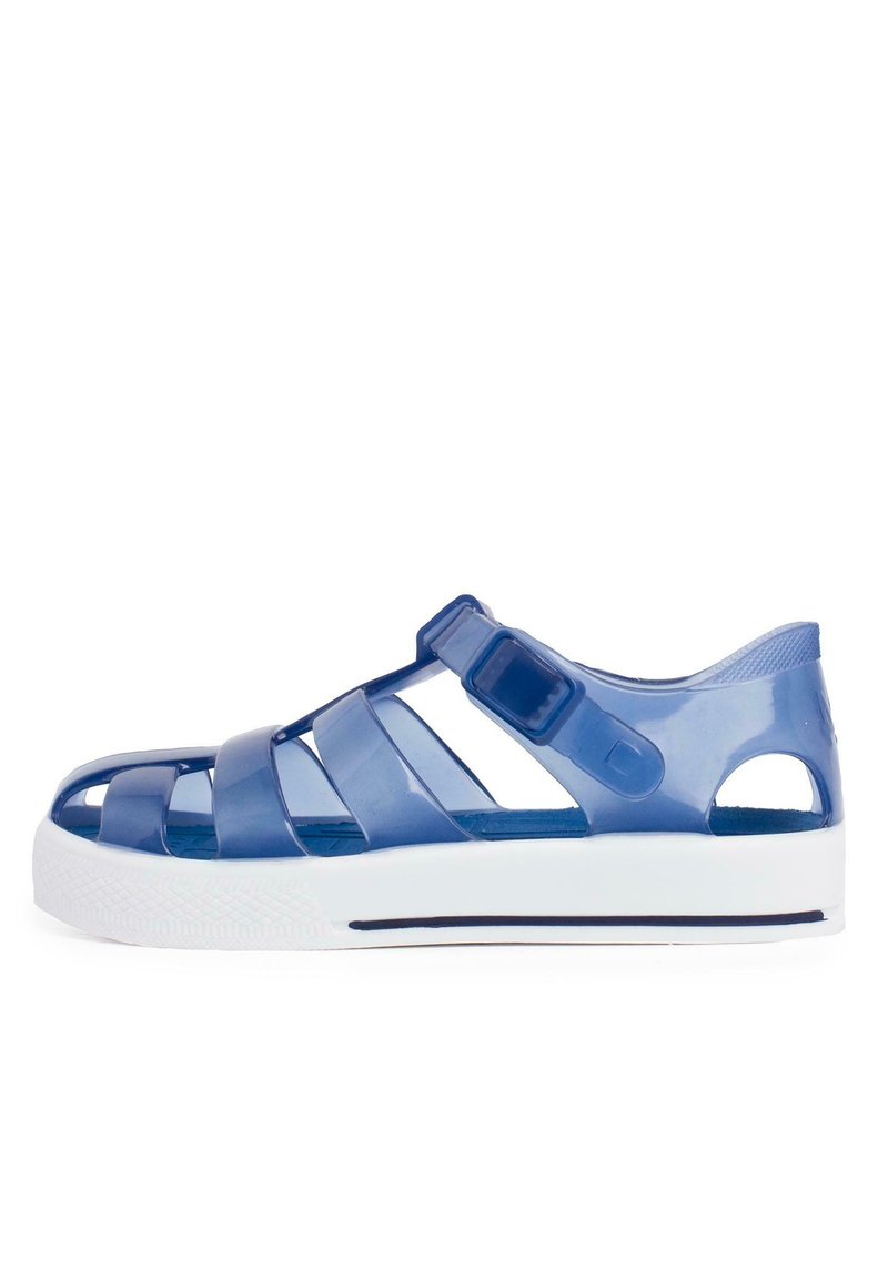 Blue translucent plastic sandals with an open design, featuring flat straps, a side buckle, and a white sole with a textured pattern.