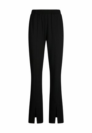 Pantalon noir en tissu extensible, avec une coupe décontractée, des jambes évasées ajustées et des fentes latérales au niveau des revers. Détail de ceinture élastique.
