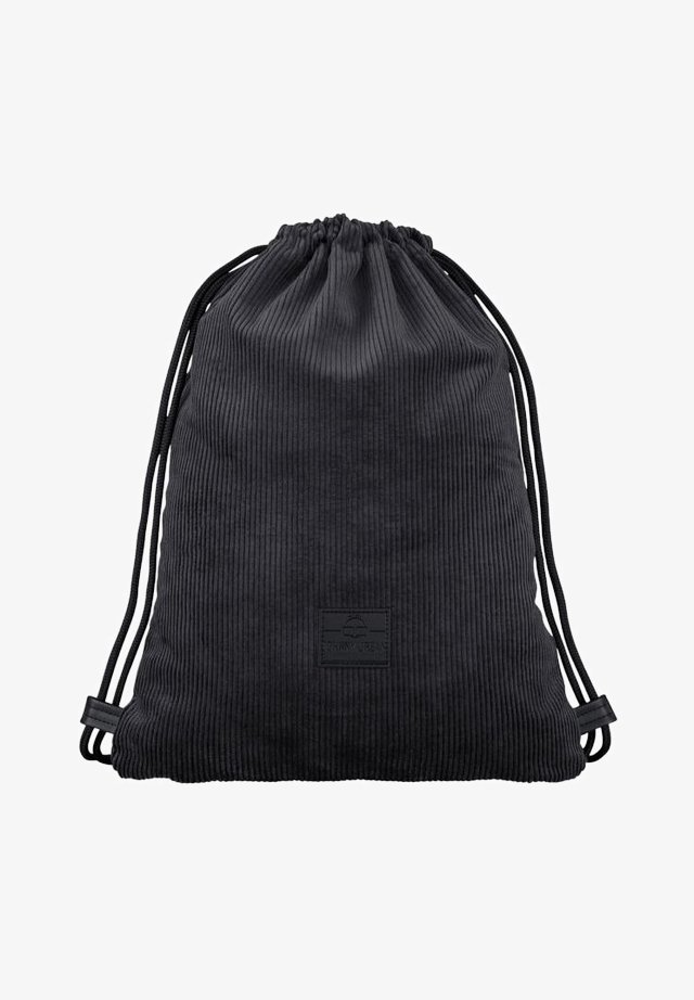 Black corduroy drawstring bag with ribbed texture, featuring a logo patch and adjustable cord handles for closure and carrying.