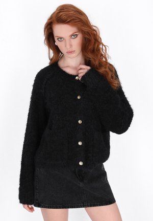 Black, fuzzy cardigan with long sleeves, round neckline, and front button closure. Features two pockets and gold-tone buttons.