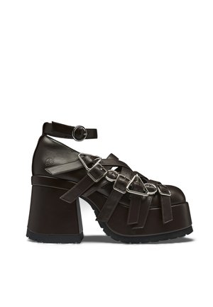 Chunky dark brown platform heel shoe with multiple buckle straps and an ankle strap with round metal buckle.