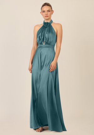 Teal satin halter gown with a rose detail at the neckline, featuring a waist cutout and flowing skirt for an elegant silhouette.