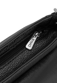 Black textured leather bag with a zip closure, featuring a silver metal zipper pull with the brand name "RYKØ" engraved on it.