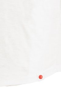 White short-sleeve shirt in lightweight fabric, featuring a rounded hem and a prominent red button accent near the bottom left.