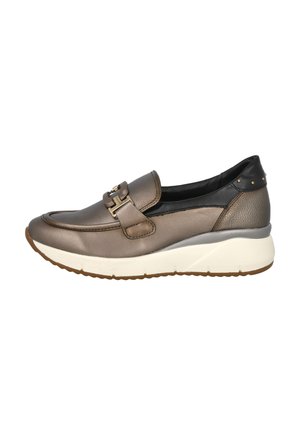 Zapato de mujer de piel bronce, tipo slip-on, con suela de plataforma blanca, acento de tacón negro con tachuelas doradas y detalle decorativo de hebilla en la parte superior.