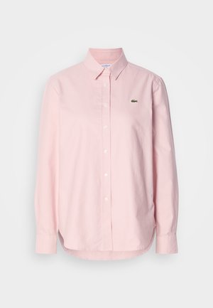 Camicia a maniche lunghe di colore rosa chiaro, con bottoni e realizzata in cotone. Presenta un colletto classico e un piccolo logo verde sul petto. Vestibilità su misura.