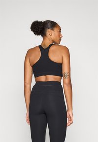 Champion SOFT TOUCH BRA LIGHT SUPPORT WITH LARGE LOGO - Sport-bh met light support - black