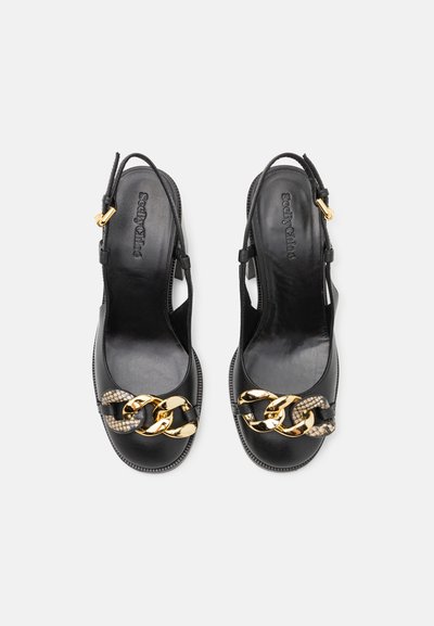 Black leather slingback shoes featuring gold chain accents and a textured detail. Smooth finish with an open toe and adjustable strap.