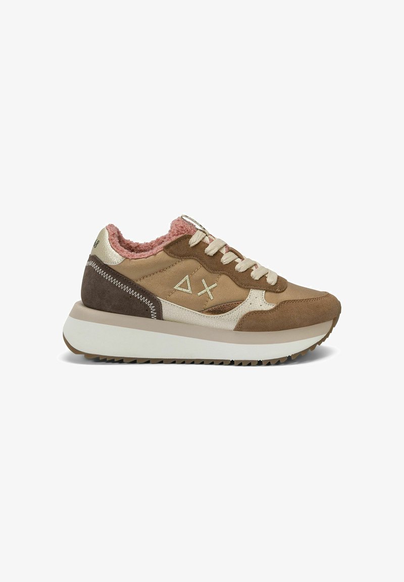 Brown and beige sneaker with pink fuzzy lining, thick white sole, lace-up front, and stitched triangle and X symbols on the side.
