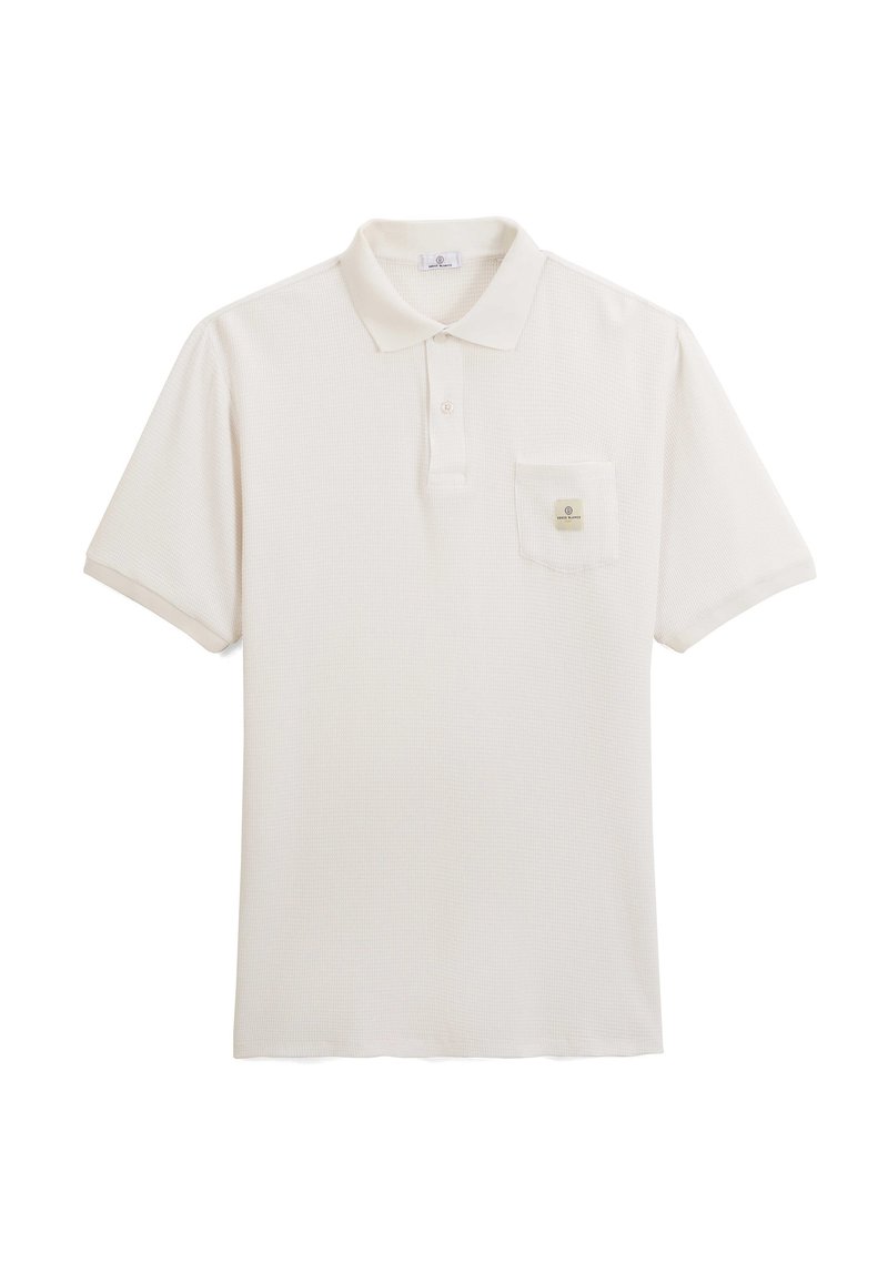 Polo di colore beige chiaro con tessuto testurizzato, maniche corte e tasca sul petto sinistro con un piccolo logo.