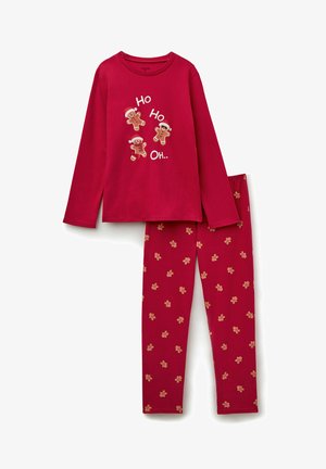 Red long-sleeve pajama top with gingerbread man graphics, paired with red pants featuring small gingerbread man patterns. Cotton material.