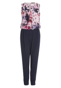 Combinaison sans manches avec un haut fleuri rose, violet et blanc, et un pantalon fuselé bleu marine uni avec des bords resserrés.