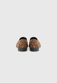 Leopard-print slip-on shoes with a soft brown fabric upper, a rounded toe, and a low black rubber sole. No visible hardware or accents.