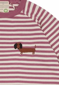 Maglietta a righe con linee rosa e bianche, caratterizzata da un dachshund marrone ricamato sul davanti. Materiale in cotone morbido con scollatura tonda.