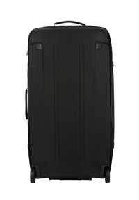 Black hard-shell suitcase with a smooth finish, vertical grooves, retractable handle, and two wheels for mobility.