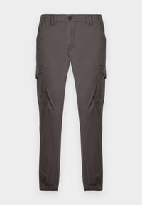 Tumši pelēkas kravas bikses ar sānu kabatām, koniskas kājas, elastīgi aproces un priekšējā daļā aizdare ar pogu. Gluda tekstūra.