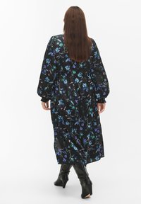 Black floral dress with long, puffed sleeves, featuring blue and green floral patterns, a cinched waist, and a flowing silhouette.