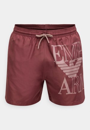 Burgundy swim shorts with an elastic waistband and drawstring. Features a large white logo print on the left side. Smooth, synthetic material.