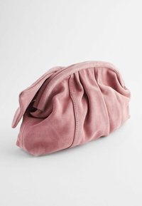 Pink suede handbag with pleated design, soft texture, and a rounded top closure. Simple stitching adds detail to the overall shape.