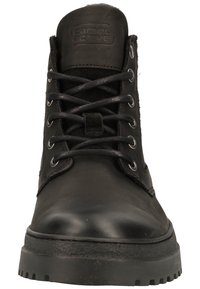 Black leather ankle boots with a smooth finish, round toe, metal eyelets, and black laces. Thick rubber outsole for traction.