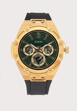 Златист часовник Guess с зелен циферблат, черна силиконова каишка, три подциферблата и златисти стрелки и индикатори.