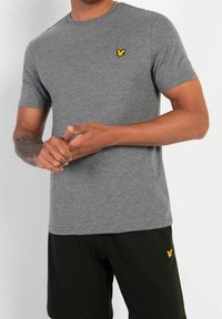 Gray short-sleeve t-shirt made of soft fabric, featuring a small yellow embroidered logo on the chest and round neckline.