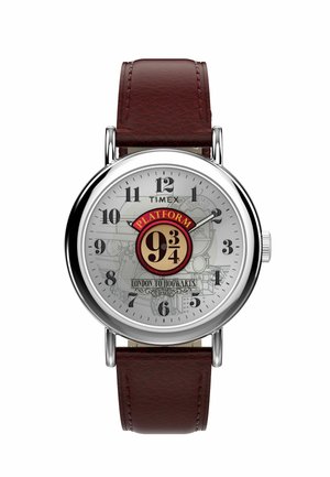 Round wristwatch with brown leather strap, silver case, and face featuring Platform 9 3/4 logo and London to Hogwarts text.