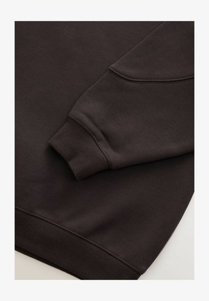 Dark brown sweatshirt with ribbed cuffs and hem. Smooth texture with a round neckline and a visible seam on the sleeve.