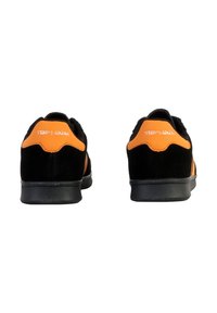 Sneakers in suede nero con accenti arancioni, caratterizzati da un design low-top, punta rotonda e suola in gomma. Logo "Teddy Smith" sul retro.