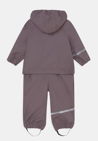 Waterproof two-piece rain suit in muted purple. Features a hood, elastic cuffs, and reflective accents on the jacket and pants.