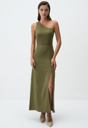 Olive green, one-shoulder maxi dress with a fitted bodice, side slit detail, and flowing fabric; complemented by pointed beige heels.