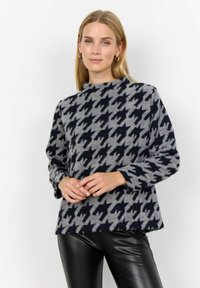 Kudum, millel on tume tume meresinine ja hall houndstooth muster, valmistatud pehmest kangast, kõrge kaelusega ja pikkade varrukatega.