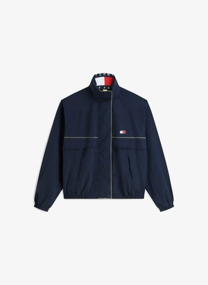 Veste zippée bleu marine avec poignets et ourlet élastiques, poches avant, petit logo Tommy Hilfiger sur la poitrine et impression du logo à l’intérieur du col.