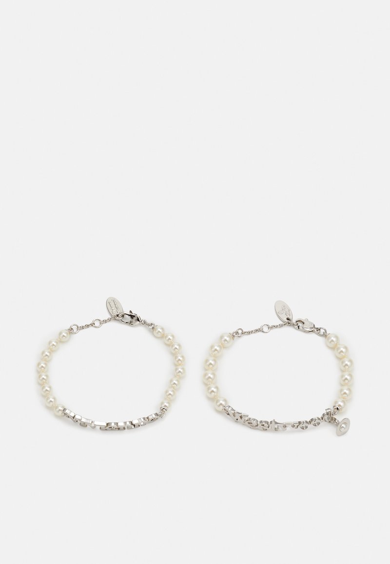 Une paire de bracelets composée de perles blanches et d'accents métalliques, avec des sections alternées de matériaux lisses et texturés. Fermeture à clapet sécurisée.