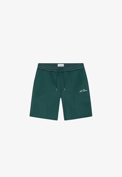 Shorts vert foncé en tissu doux, dotés d'une ceinture élastique avec un cordon de serrage et des poches latérales. Logo brodé sur le devant.