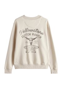 Sweat-shirt de couleur crème avec un col rond, des poignets côtelés et un motif décoratif représentant "Yellowstone Dutton Ranch" et un crâne de taureau.
