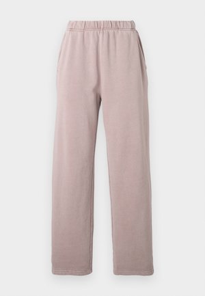 Lösa mauve joggers med elastisk midja och sidofickor på en enkel vit bakgrund.