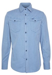 Ljusblå, långärmad skjorta i denimliknande tyg, med två bröstfickor, blå knappar och en spetskrage.