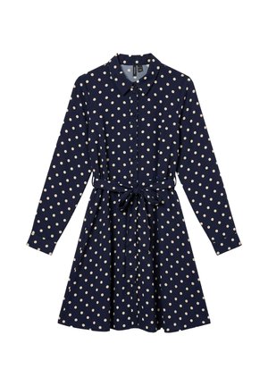 Robe-chemise bleu marine à manches longues, à pois crème, avec un col pointu, des boutons sur le devant et une ceinture nouée à la taille.