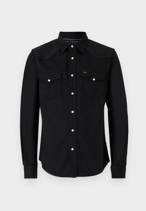 Schwarze Jeanshemd mit langen Ärmeln, spitzem yoke, zwei Brusttaschen und silberner Knopfverschluss. Glatte Textur und taillierte Passform.